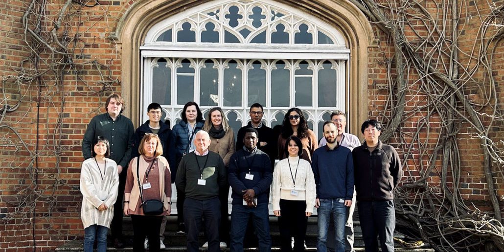 DIGIT Lab team members posing for a group photo in front of the entrance to Cumberland Lodge, with the building's facade and windows visible.